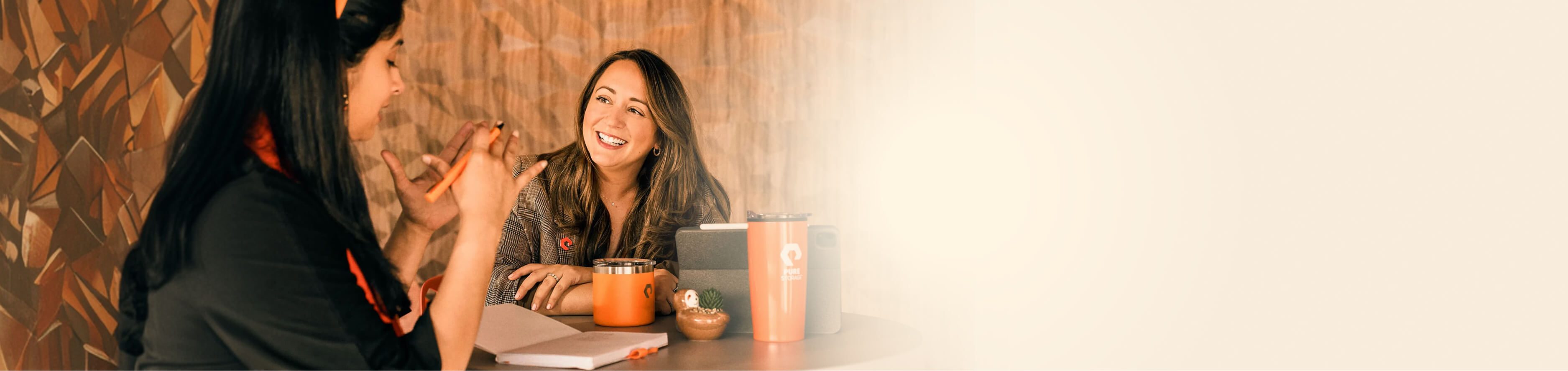 Two friends enjoying conversation over drinks at a café