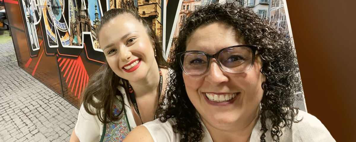 Smiling friends posing for a selfie at an event