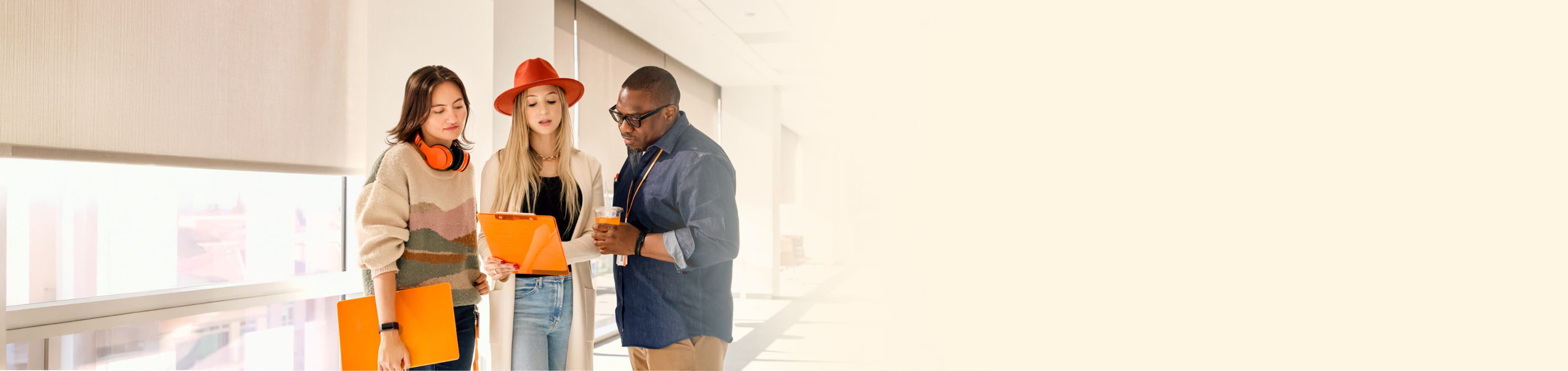 Group of three people engaged in a discussion indoors