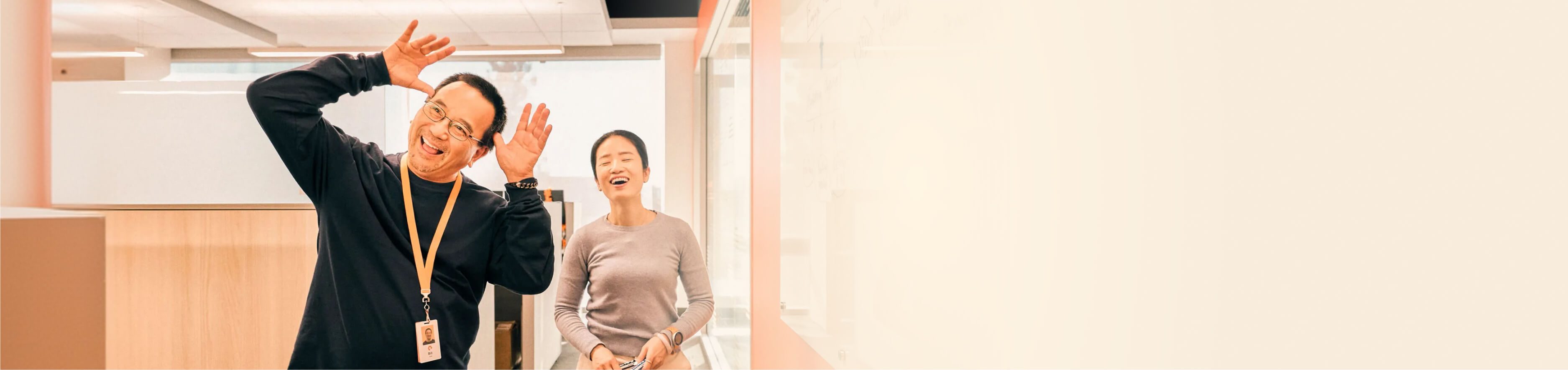 Two individuals engaged in a discussion in a modern office environment