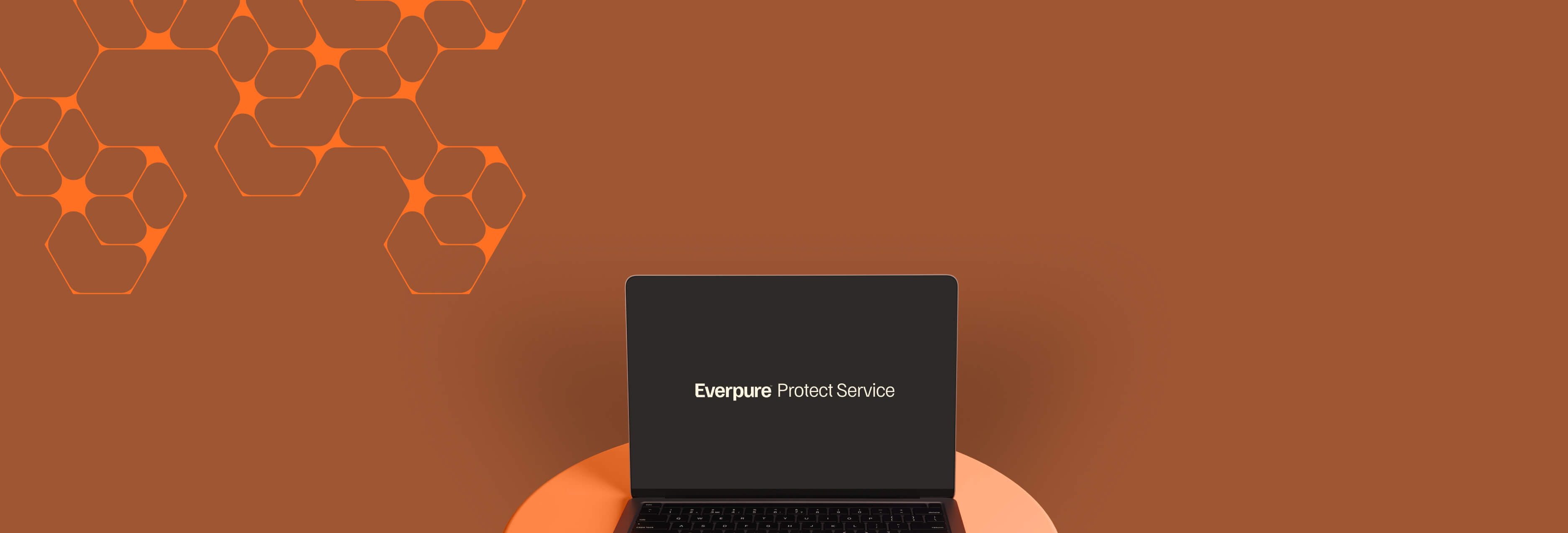 Modern laptop atop a circular surface against a rich orange backdrop featuring geometric designs