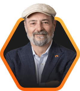 Headshot of Pure Storage CEO, Charlie Giancarlo, smiling, wearing a cap and a jacket