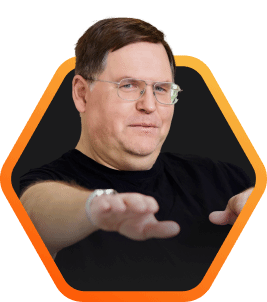 Pure Storage Founder, John Colgrove, with hands extended forward, dressed in a black shirt