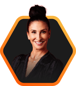 Confident woman with a sleek bun hairstyle, featured in a hexagonal frame on a dark background