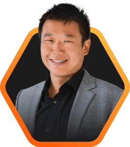 Smiling portrait of Pure Storage CTO, Rob Lee, in a stylish blazer with a warm expression