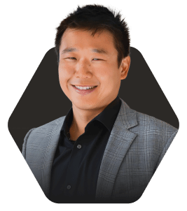 Smiling Business Professional in a Blazer featured in a hexagonal frame on a dark background