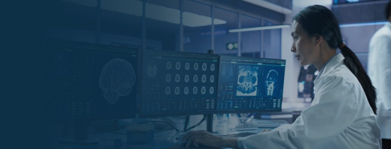 Researcher Analyzing Data on Computer Screens in a Modern Laboratory