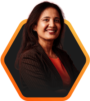 Professional portrait of a smiling individual in a blazer with arms crossed